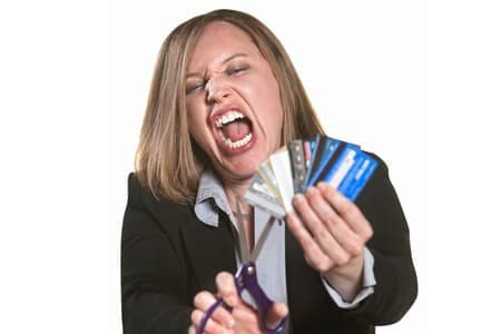 A woman cutting up credit cards